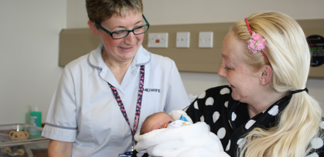 Midwife with patient and their baby
