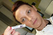 staff member holding a blood sample in a tube