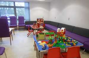 Picture showing the interior of the childrens area various toys etc and seating area