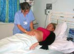 Patient being seen to by maternity staff at an antenatal clinic.