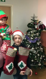 Two little boys with a Christmas stocking