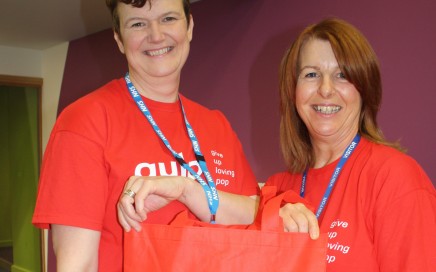 Two women holding a bag with Gulp written on it