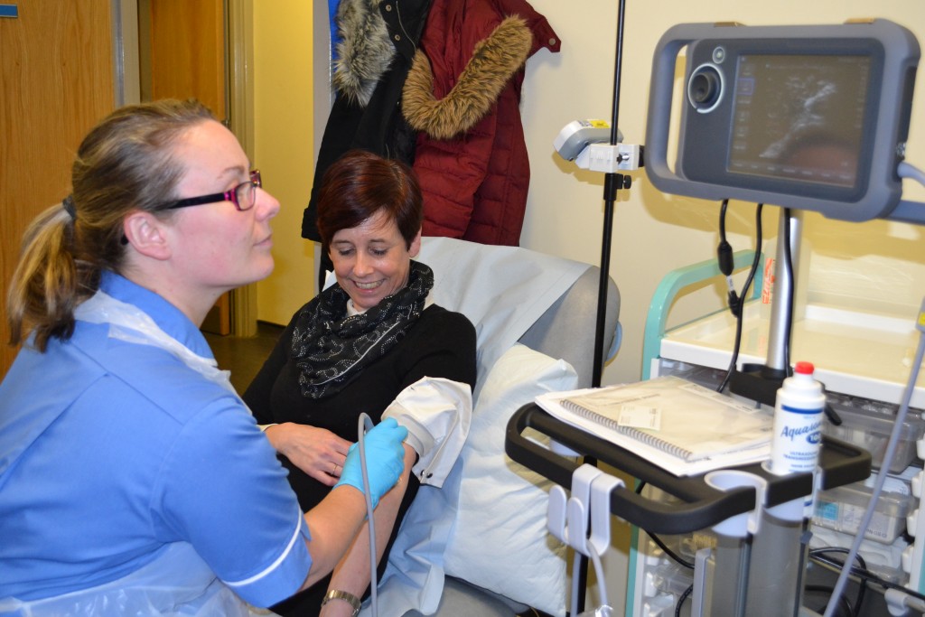 IV Therapy Staff Nurse Jenny Ball uses the new ultrasound, bought using funding from Blue Skies Hospitals Fund, to check the veins of Jan Bamber, Interim IV Lead Nurse, at South Shore Primary Care Centre