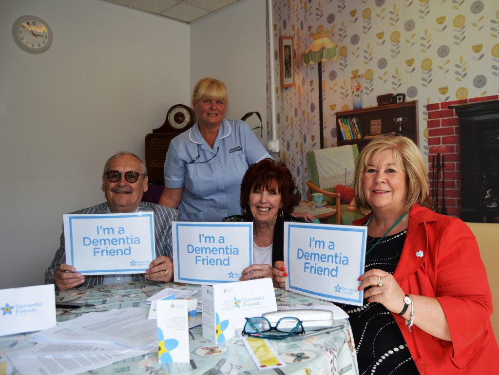 Assistant Practitioner Dawn with Bobby Yvonne and Brenda signing up to be Dementia Friends
