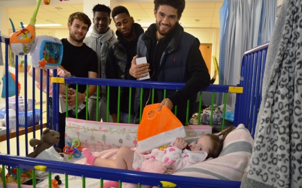 Blackpool footballers Andy, Armand, Jamille and Kelvin with Lexi-Rose