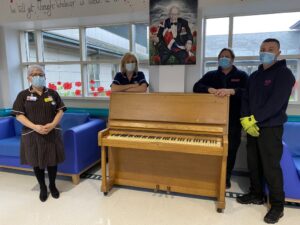 Staff at BTH receive a donated piano for staff and patients