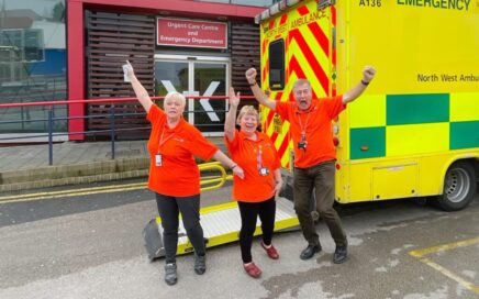 Volunteer colleagues cheering outside of the emergency department