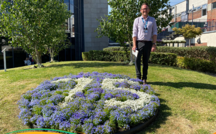 Darren Yarnald next to the NHS75 flowers