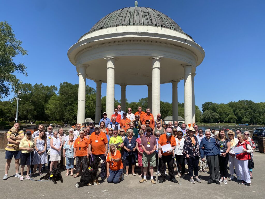 Large group of volunteers at picnic in the park event