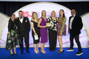 A photo of the team from Blackpool Teaching Hospitals as they celebrate winning an HSJ Patient Safety Award at an event in Manchester.